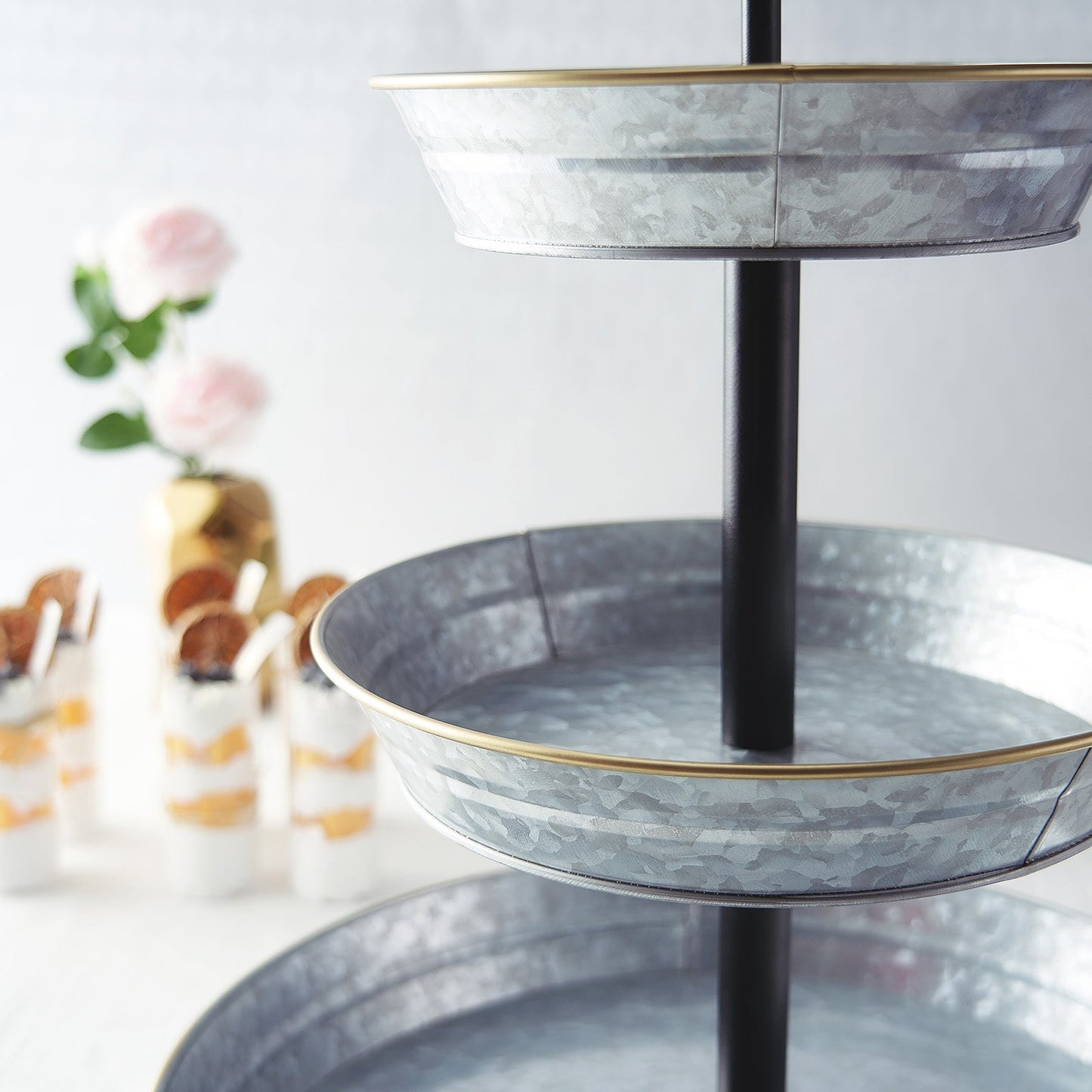 Galvanized metal 3-tier serving tray for rustic dessert display.