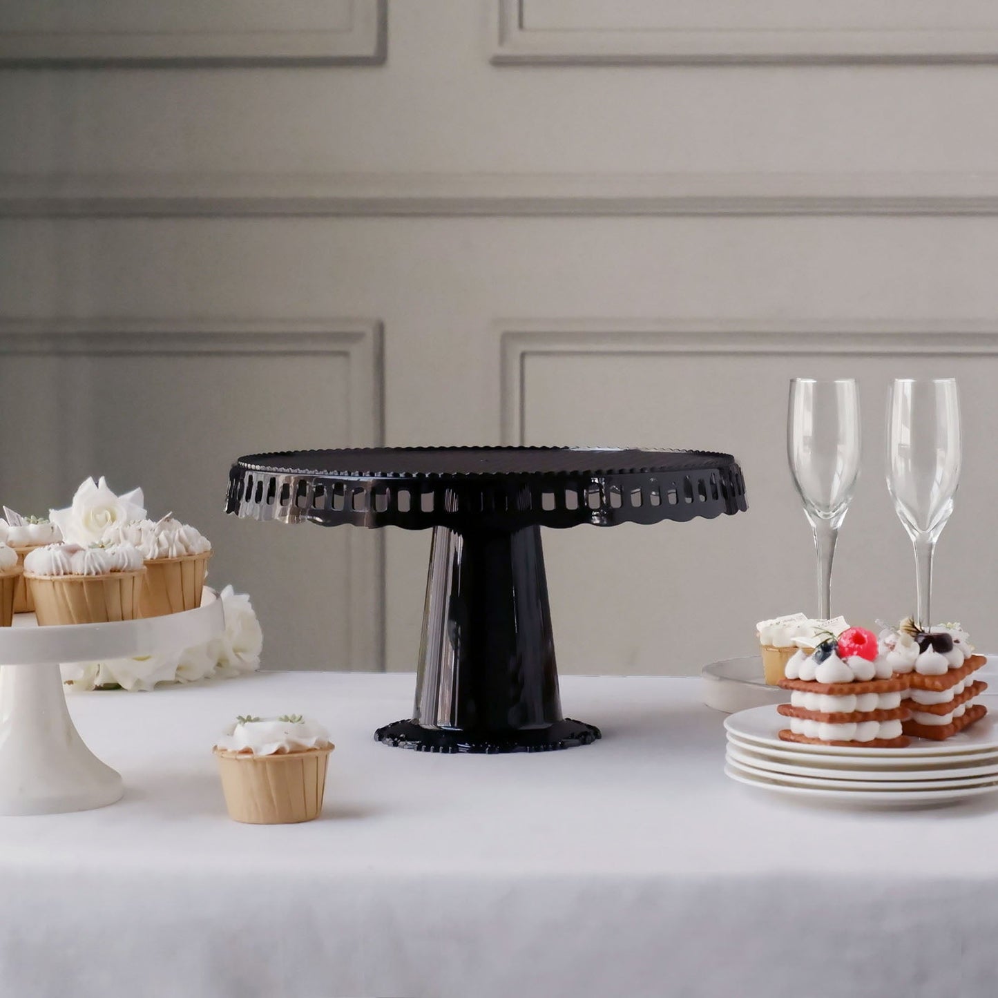 Black round pedestal cupcake stand with interchangeable ribbon trim edge.