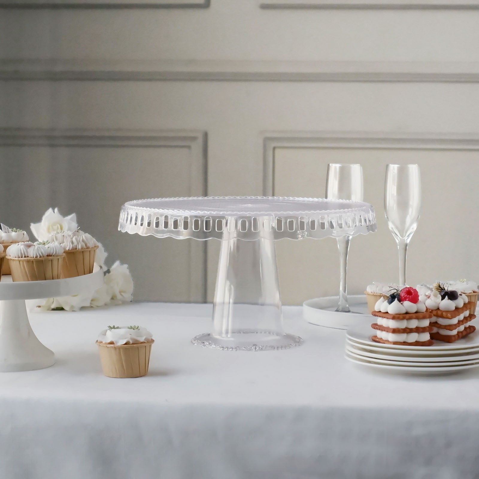 Clear round pedestal cupcake stand with interchangeable ribbon trim edge.