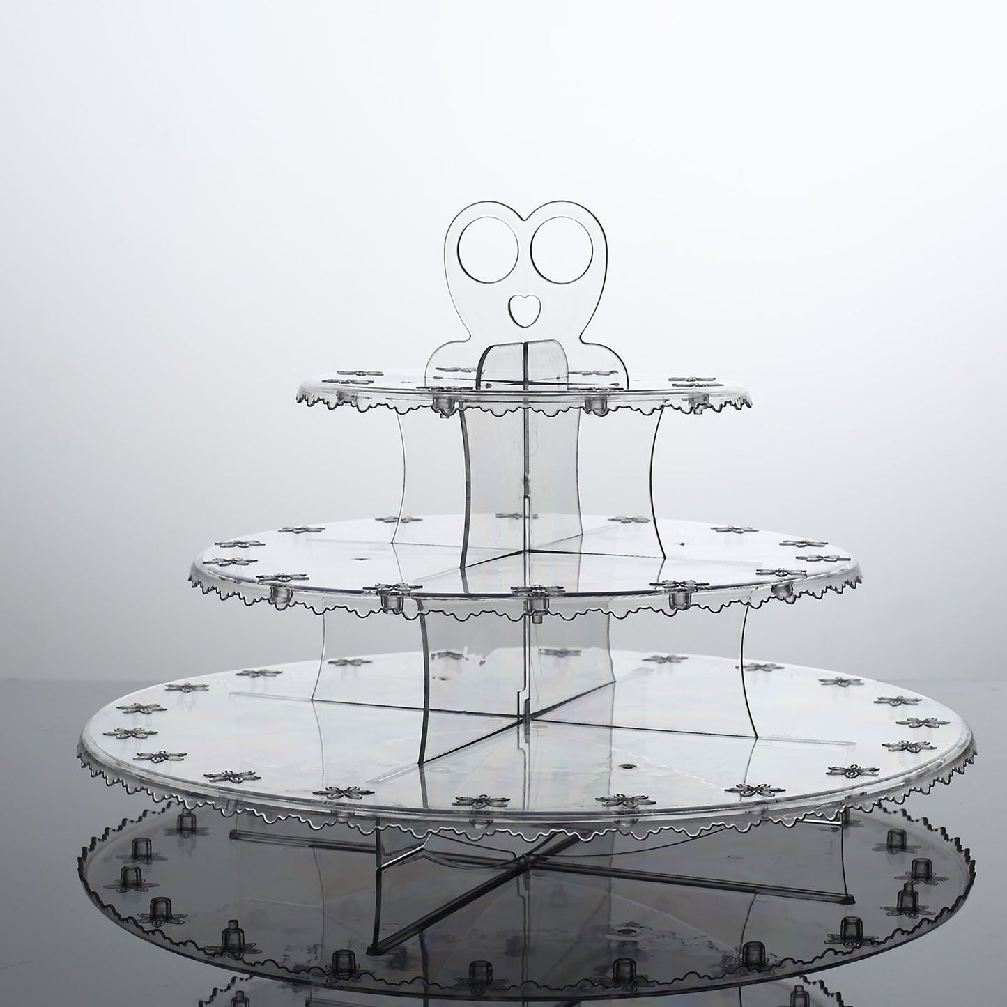 Clear 3-tier round plastic cake pop holder with floral cut rims.