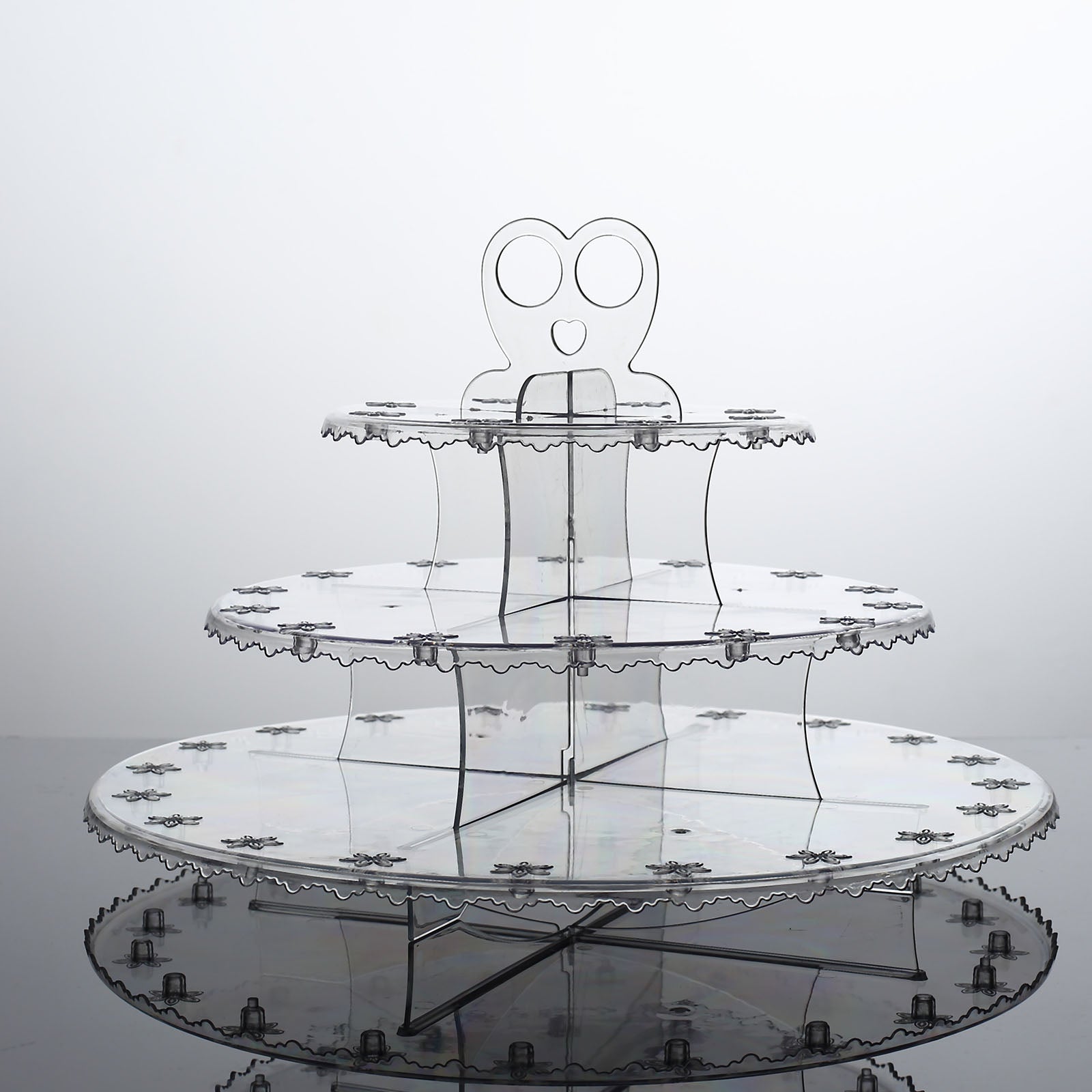Clear 3-tier round plastic cake pop holder with floral cut rims.