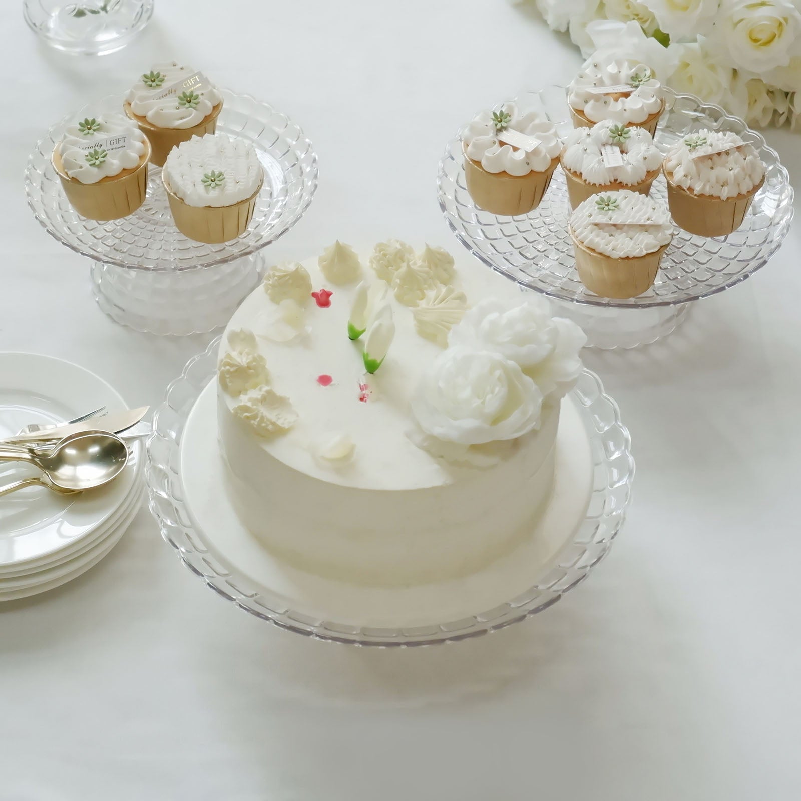 Clear contemporary pressed plastic cupcake stands displaying desserts.