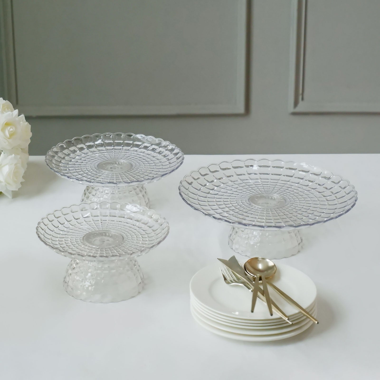 Clear contemporary pressed plastic stackable cupcake stands in three sizes.
