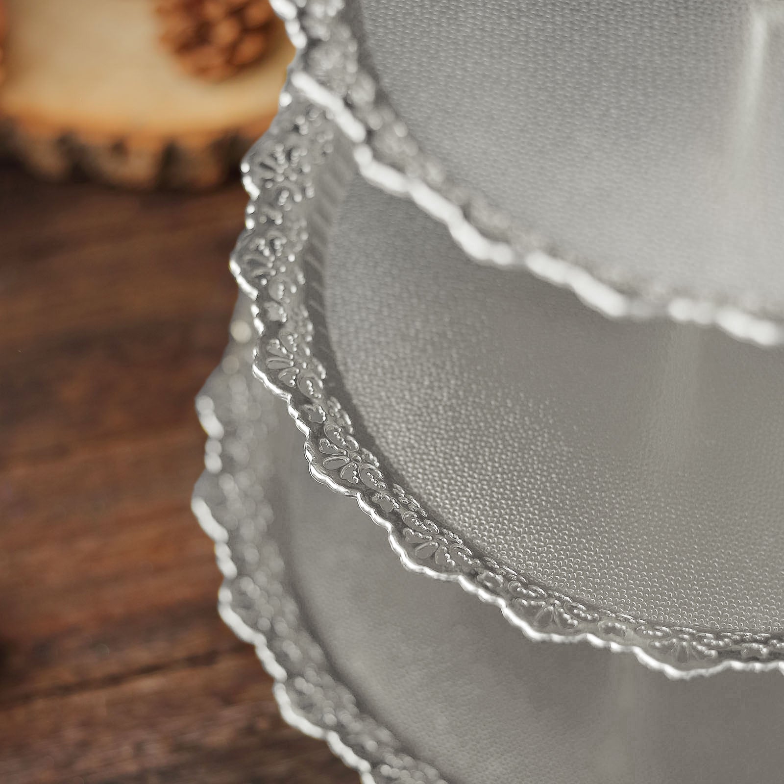 Metallic silver 3-tier round cupcake stand with lace cut edges.
