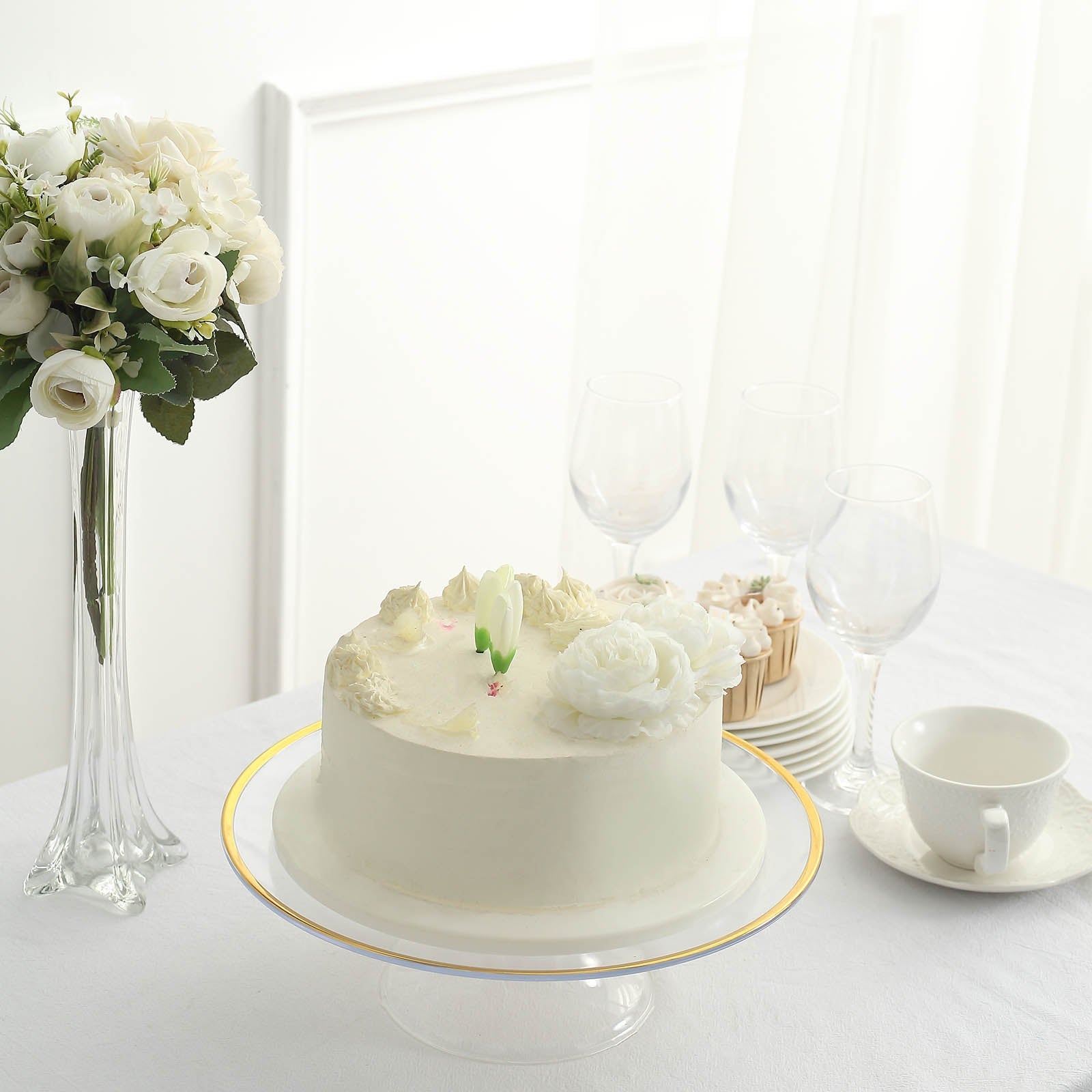 Clear plastic cupcake display riser with gold rim, perfect for desserts.
