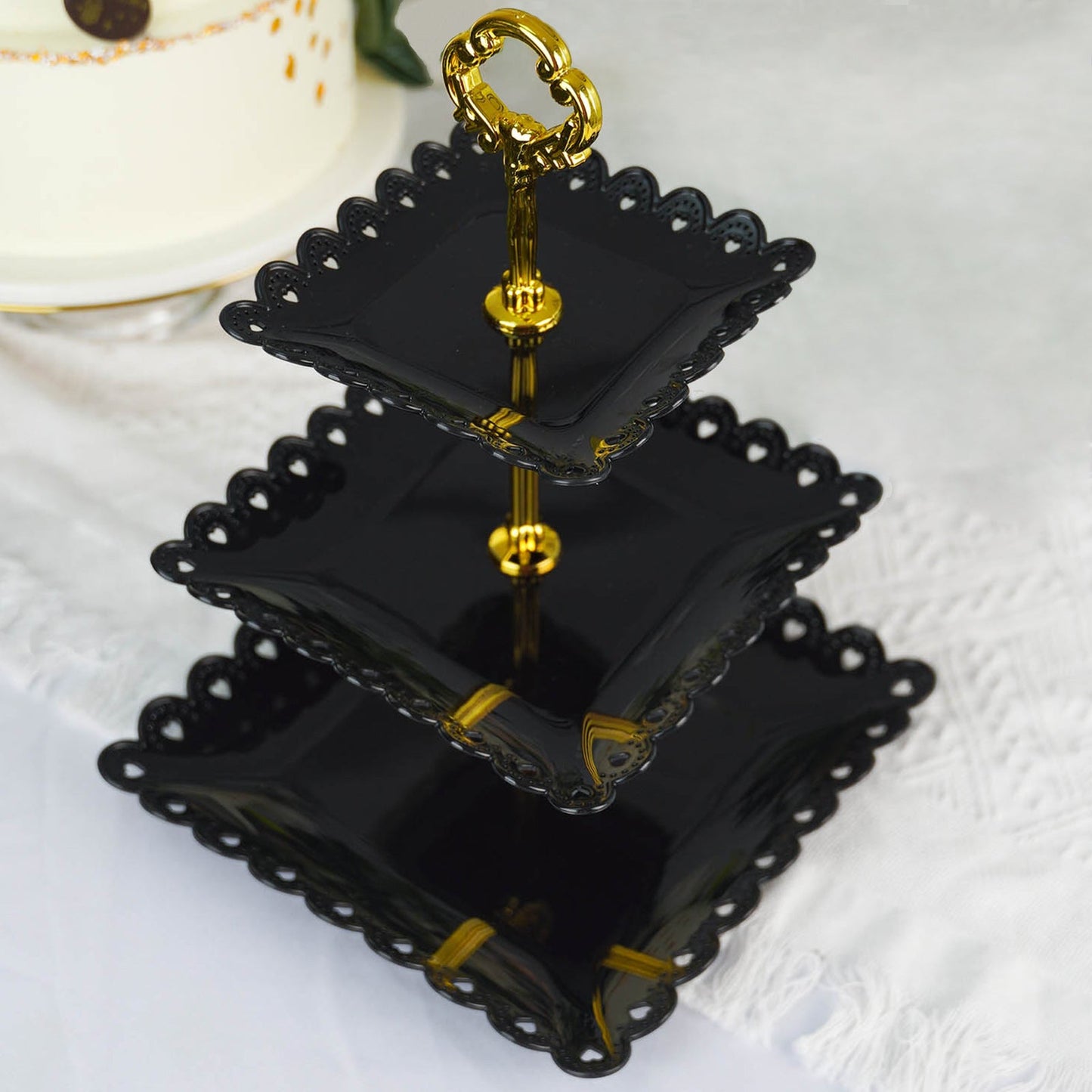 Black and gold 3-tier cupcake stand with heart wavy edge and top handle.