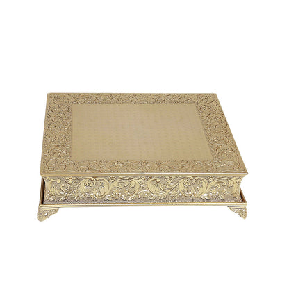 Gold embossed square cake pedestal, perfect for displaying desserts.