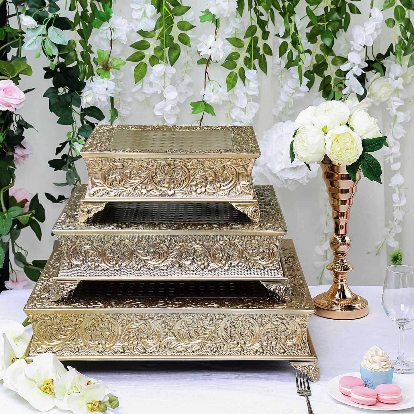 Gold embossed cake pedestal with ornate design, perfect for elegant displays.