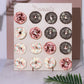 Donut bar display stand with pink and chocolate donuts on a beige background.