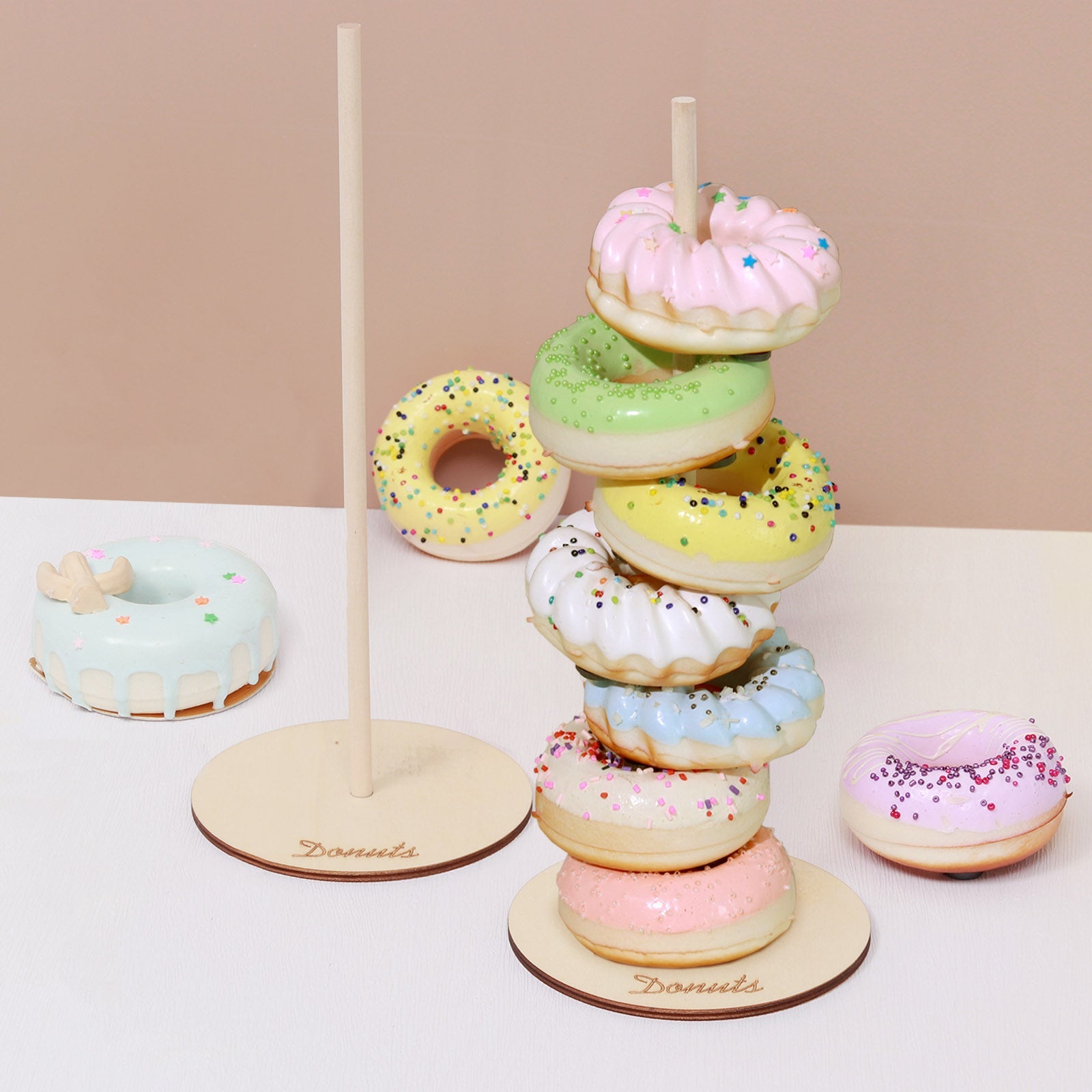 Colorful donut bar display stand with pastel donuts for dessert presentation.