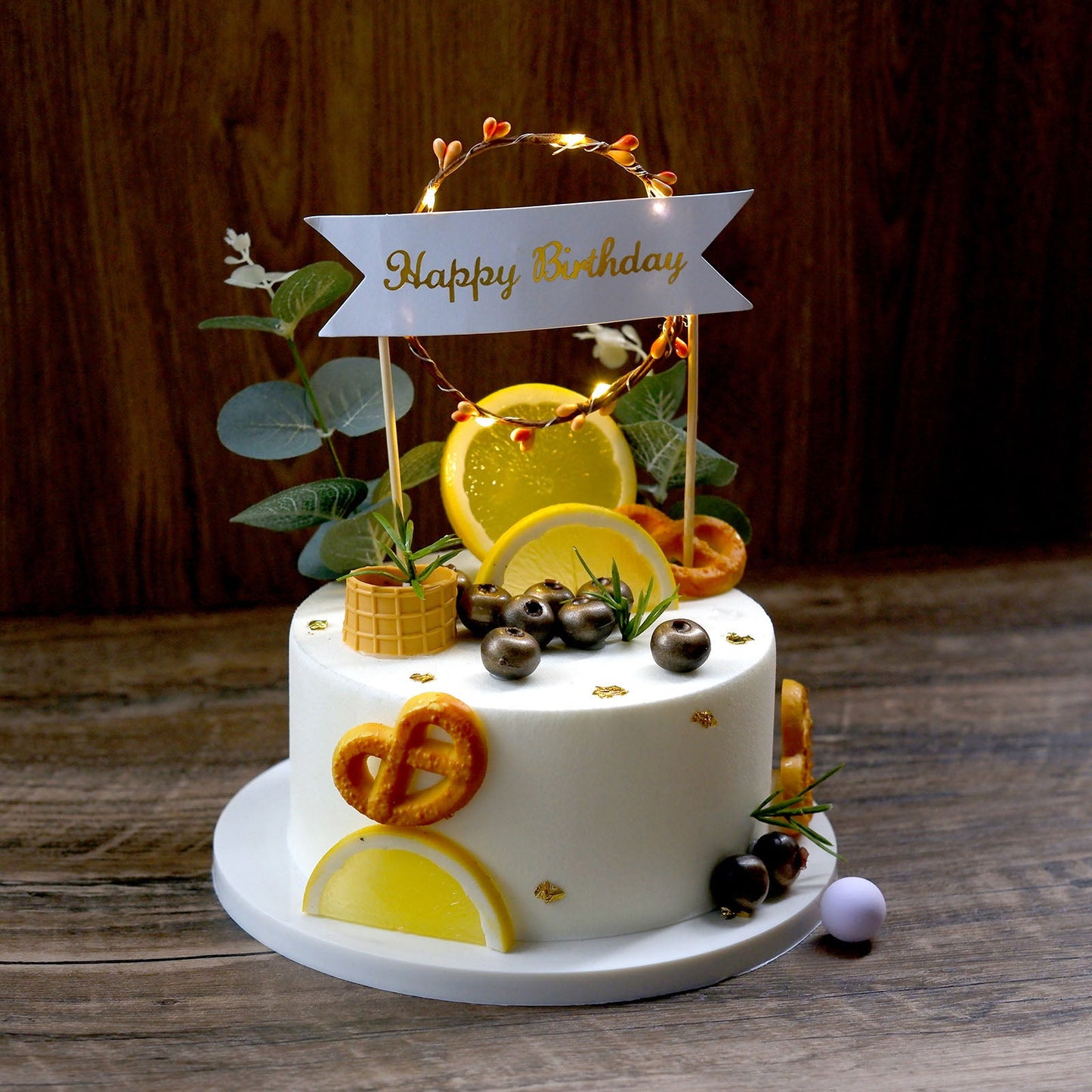 LED light up wreath birthday cake topper with yellow decorations.