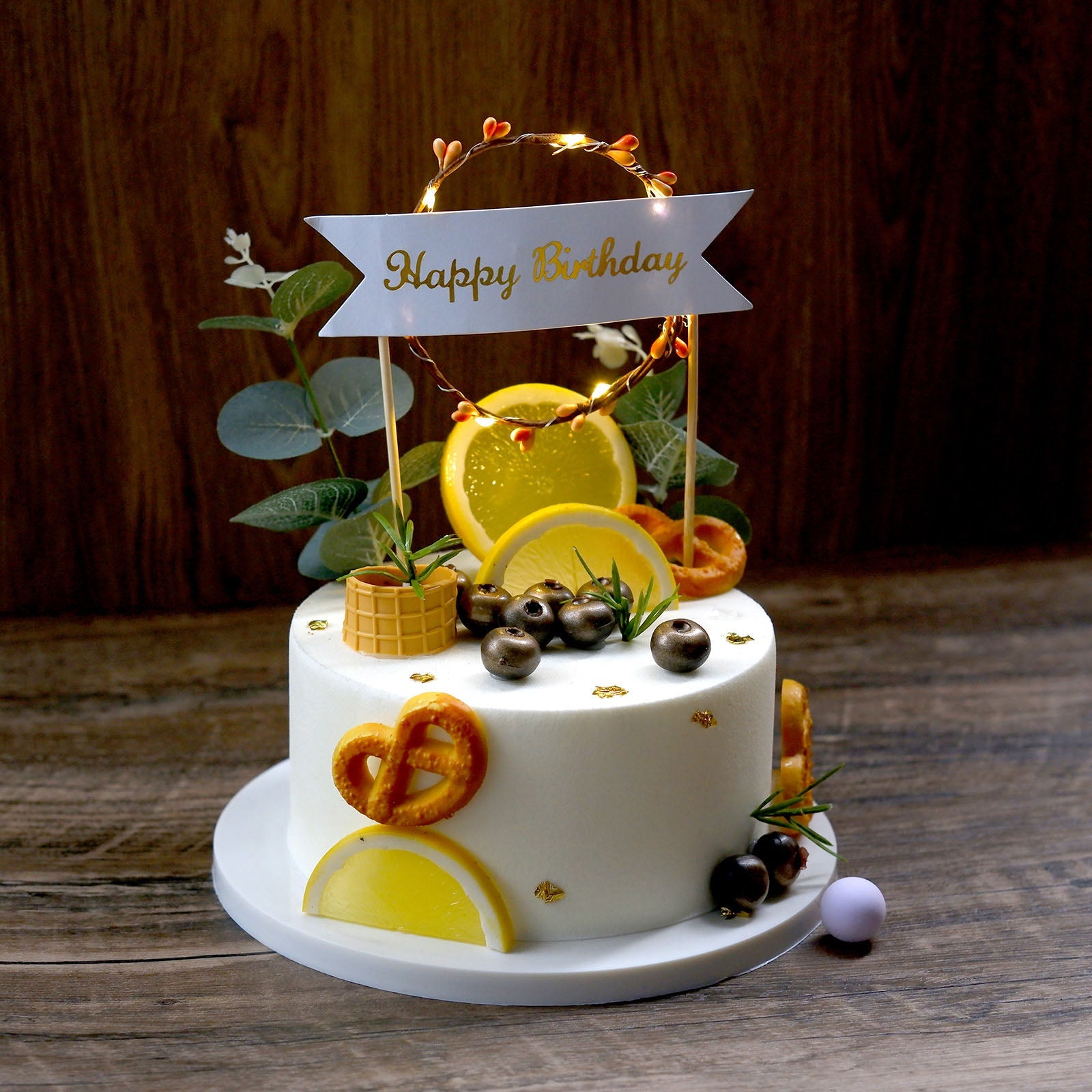 LED light up wreath birthday cake topper with yellow decorations.