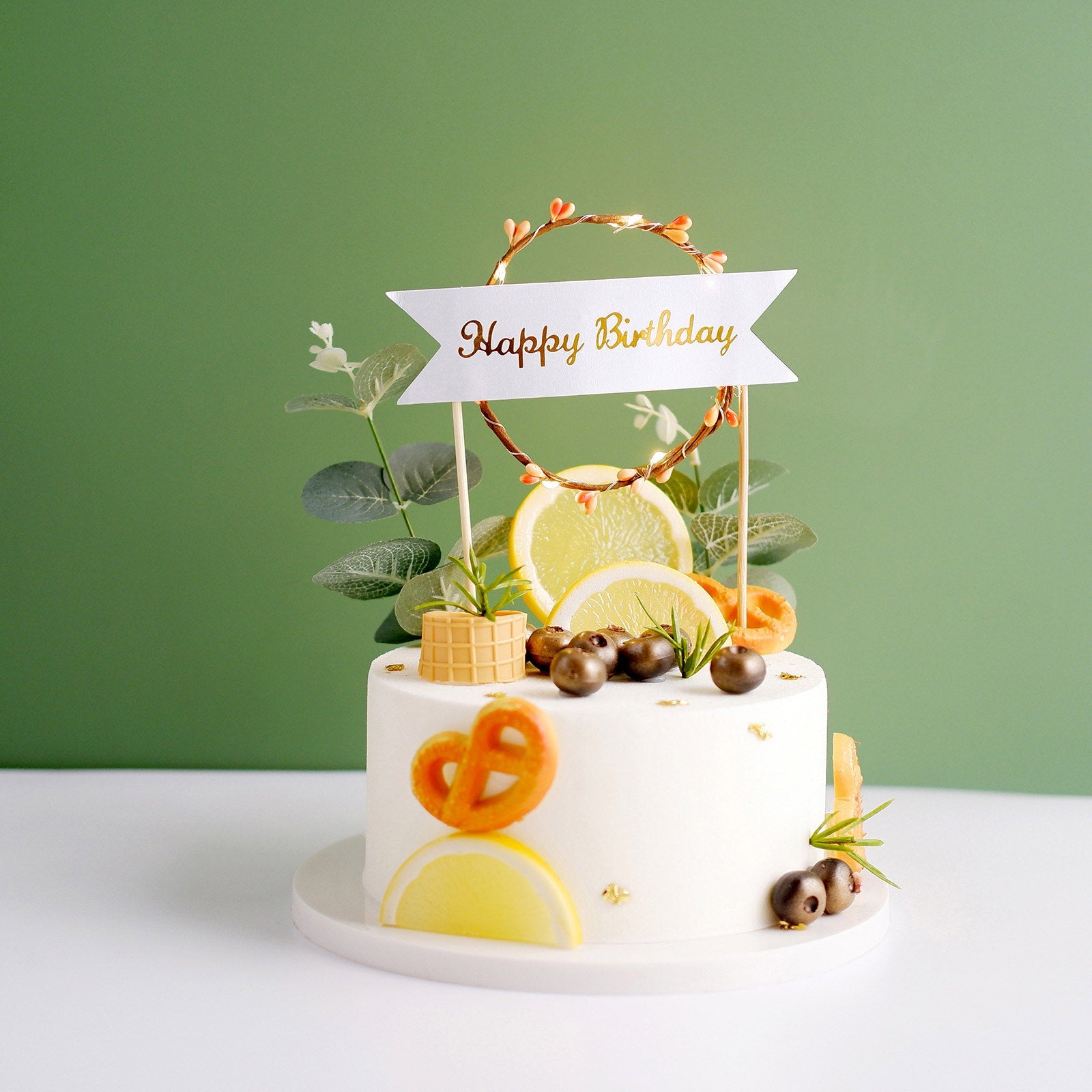 LED light up wreath birthday cake topper with fruits and greenery decoration.