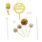 Gold birthday cake topper and decorations with white and gold accents.