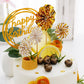 Gold birthday cake topper with mini fans and confetti balloons decor.