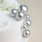Silver faux pearl balls cake topper picks on a white cake.