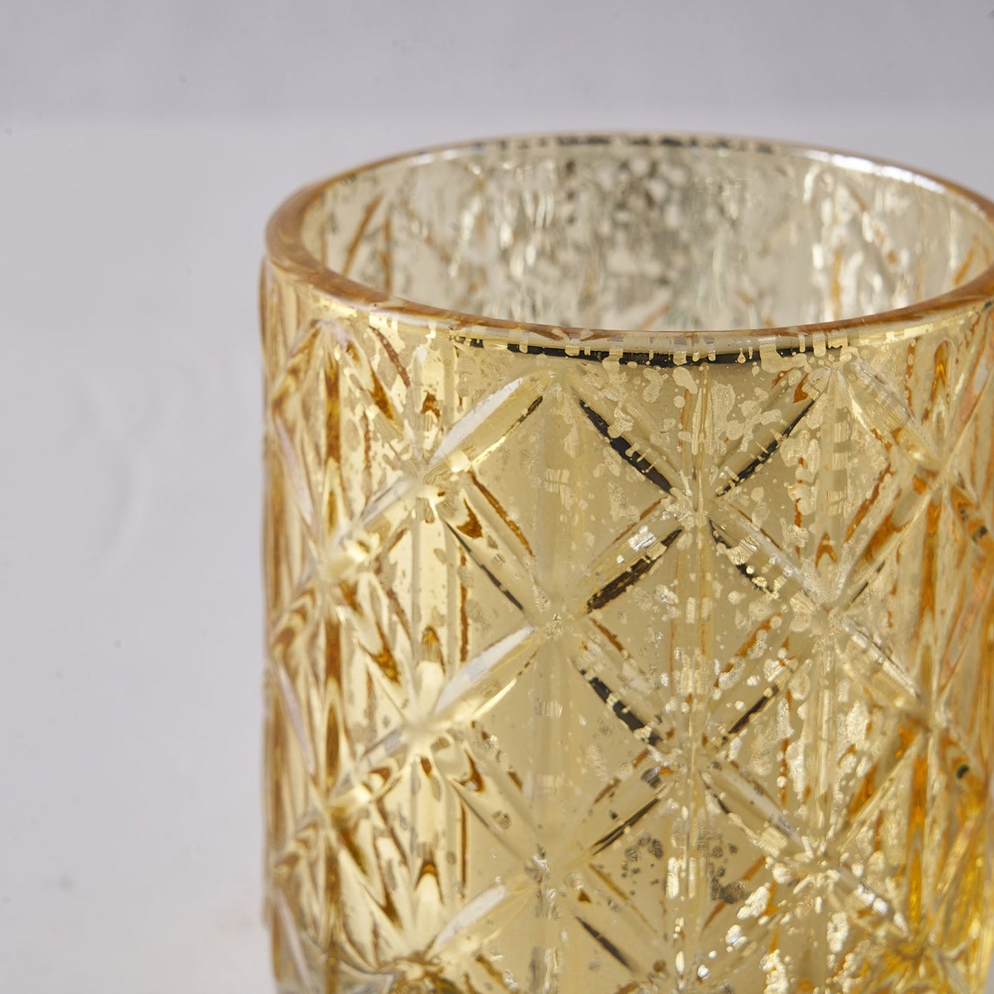 Shiny gold geometric glass candle holder, perfect for tealights.