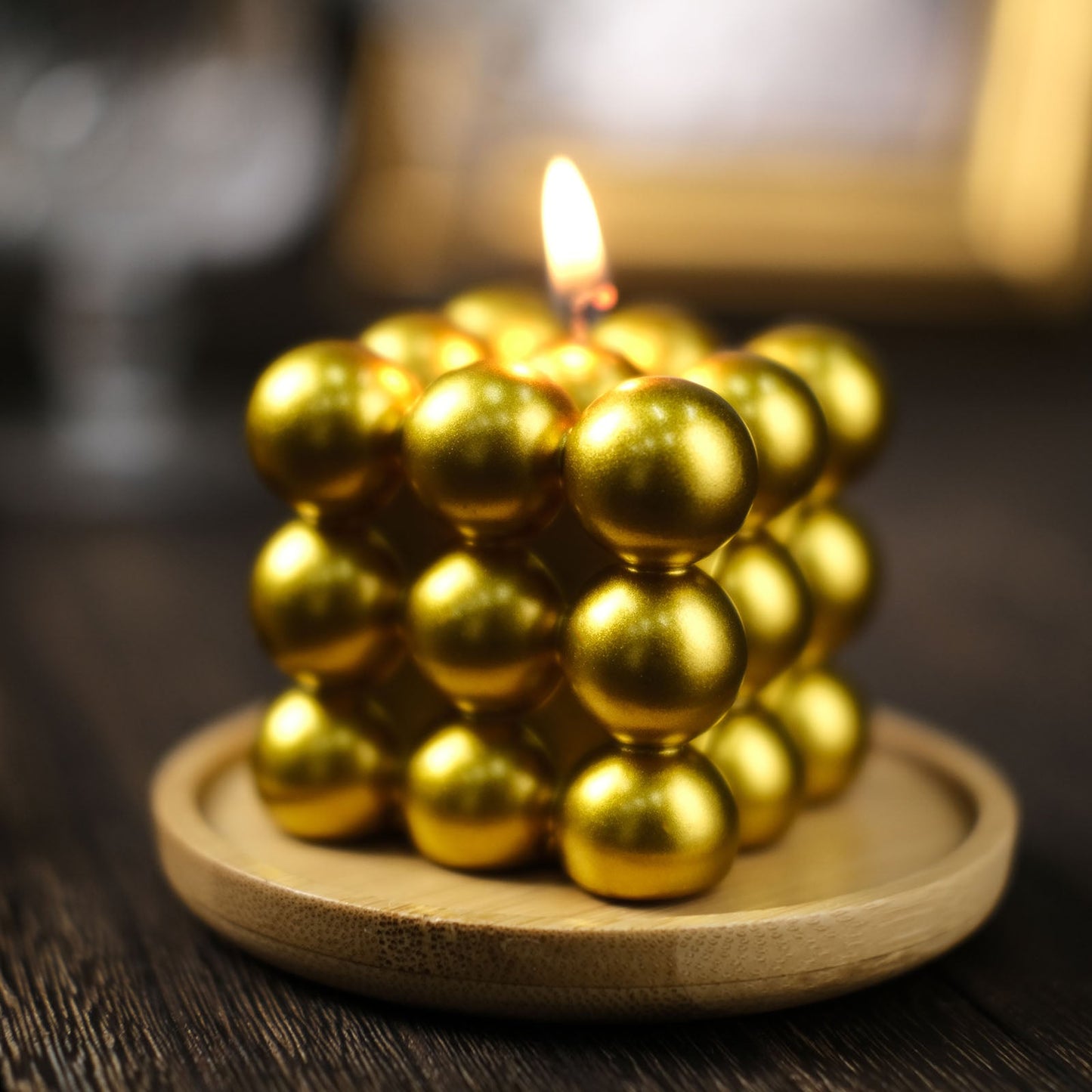 2" Metallic Gold Bubble Cube Candle Set on a wooden plate, unscented and long-burning.