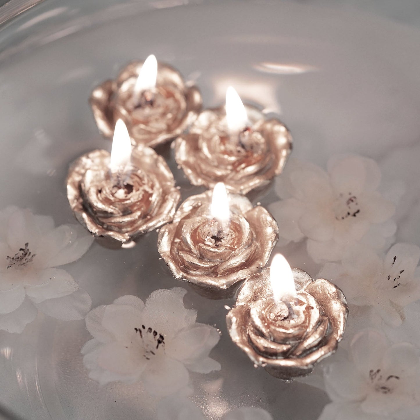 Rose gold mini rose floating candles for wedding vase fillers.