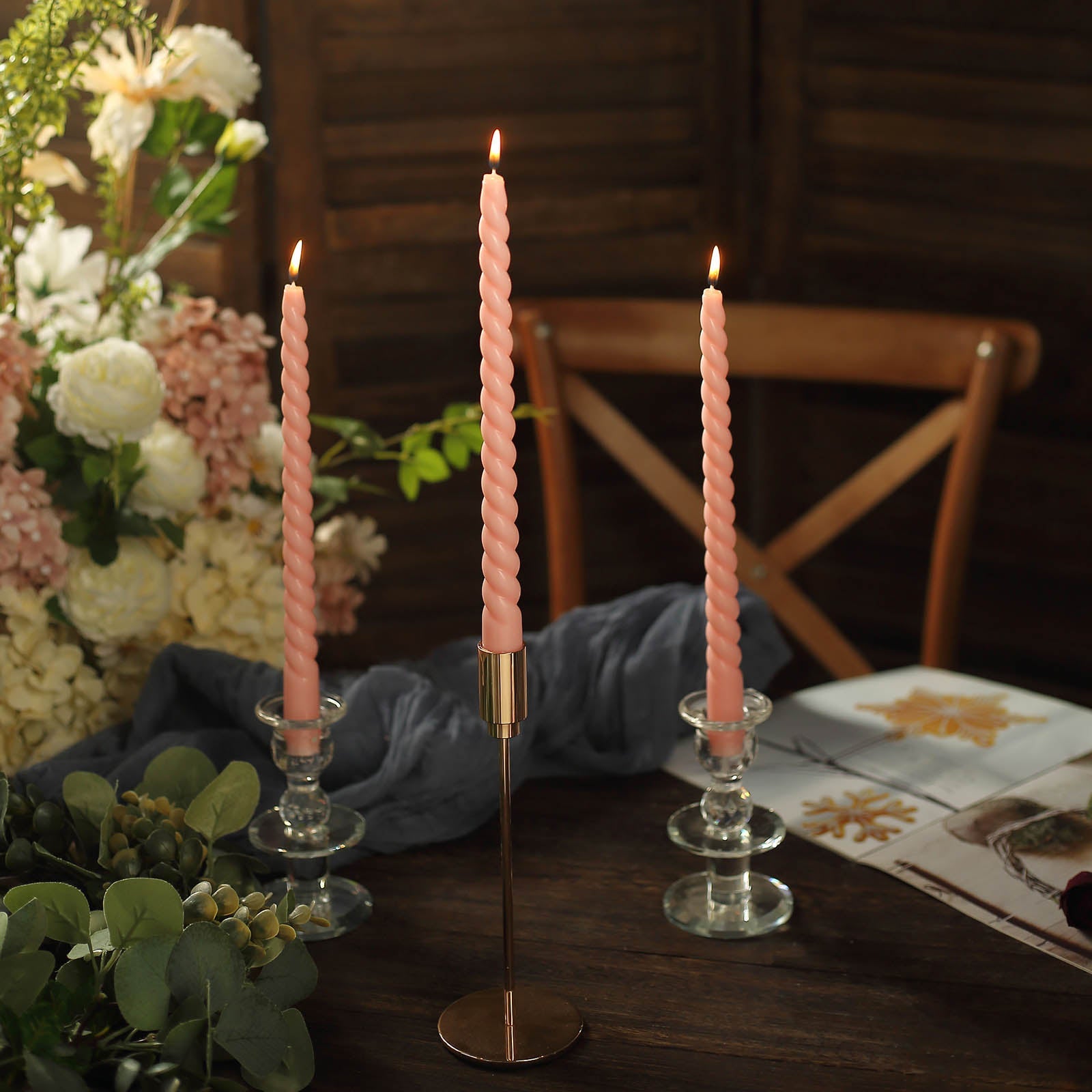 Blush premium unscented spiral wax taper candles in candle holders.
