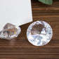 Clear plastic diamond-shaped place card holders for table decorations.