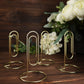 Gold metal paperclip card holder stands for table numbers or menus.
