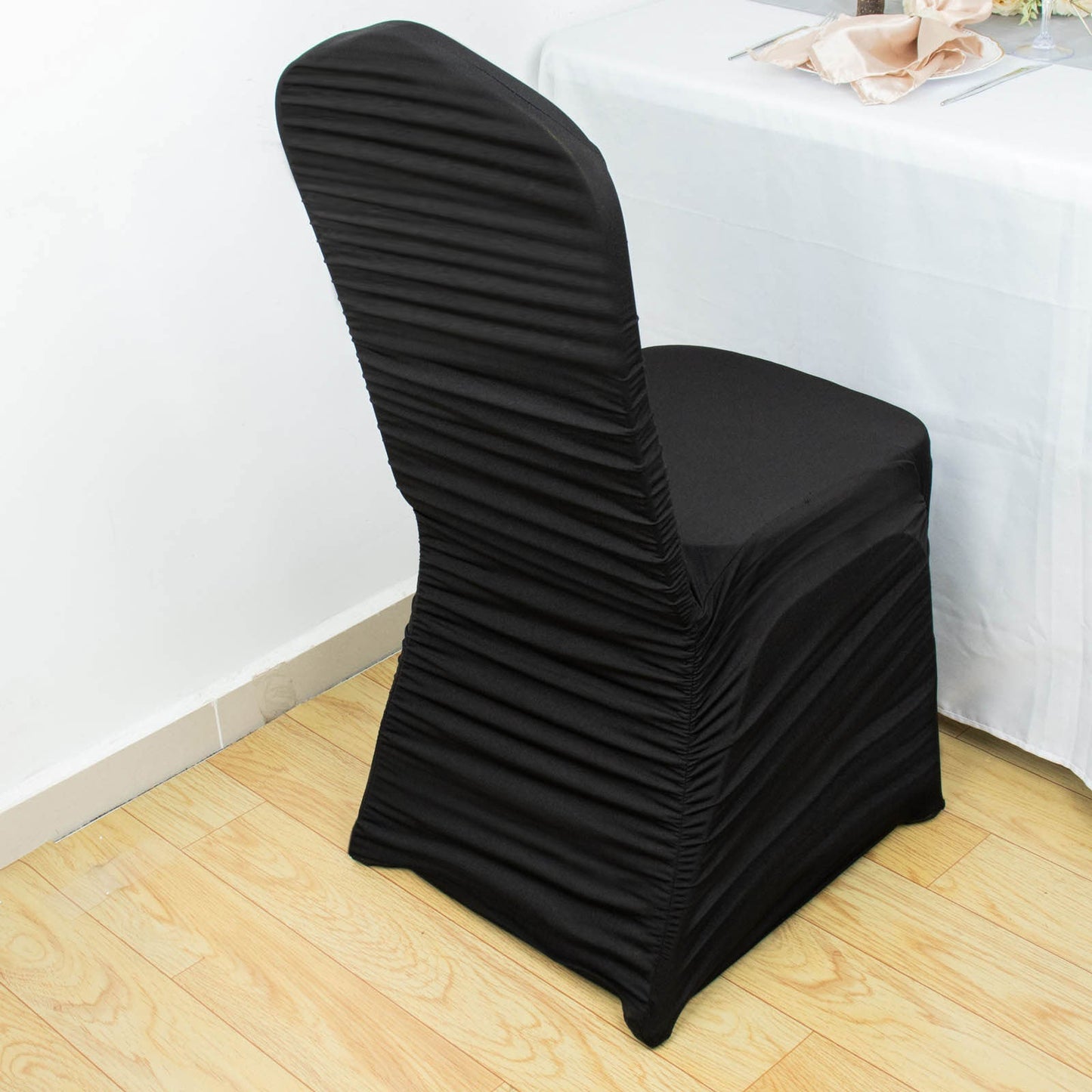 Black fitted banquet chair cover in stretch spandex.