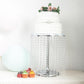 Metallic silver cake stand with crystal chains displaying a decorated cake and cupcakes.