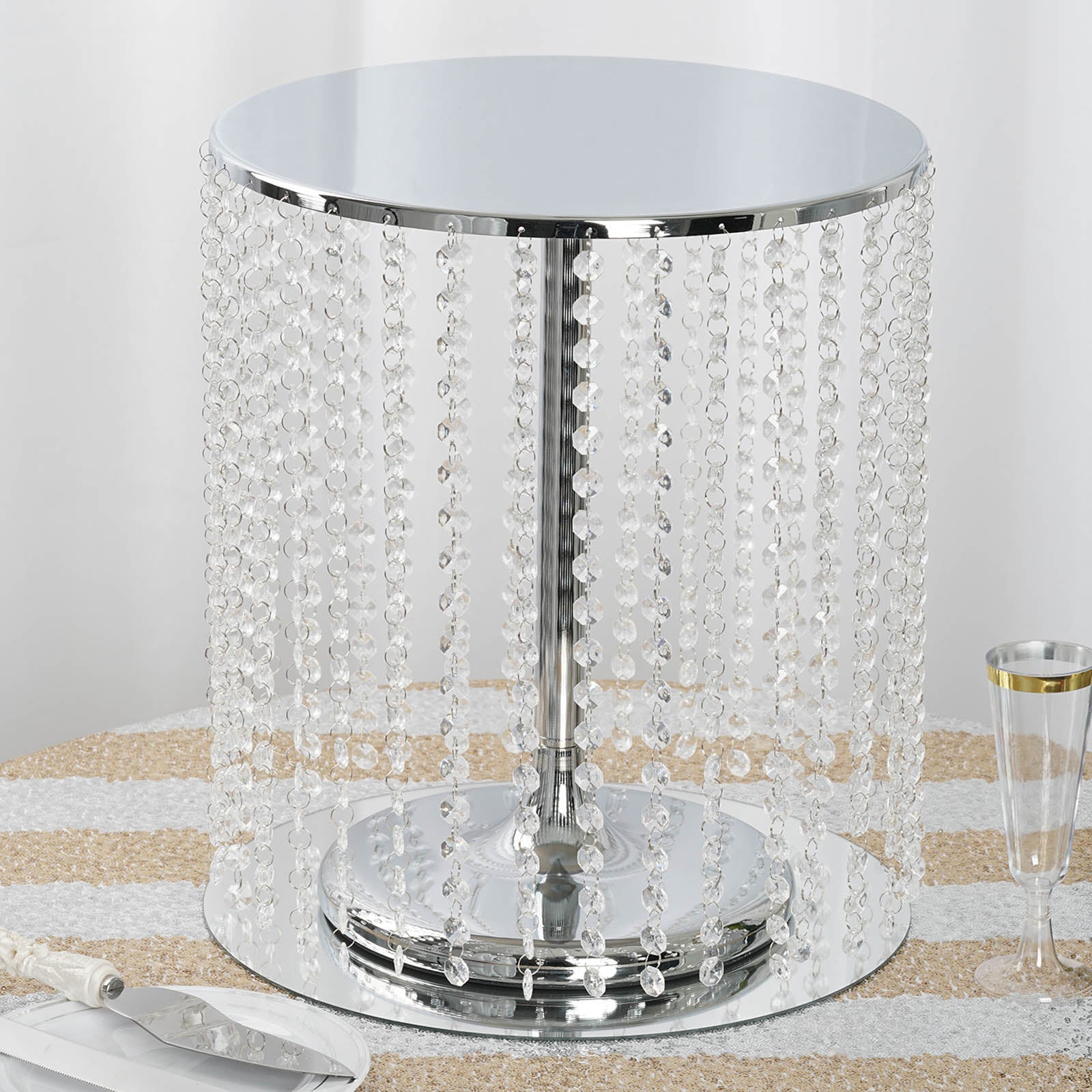 Metallic silver cake stand with crystal chains, 14" round and 16" tall.