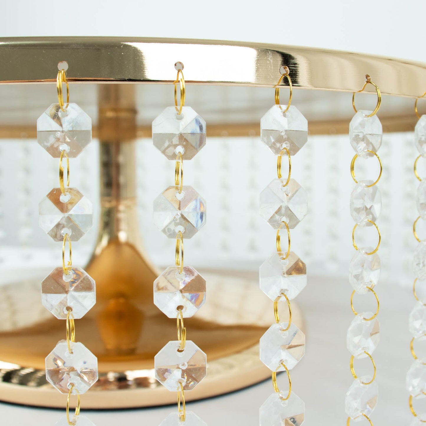 18" round metallic gold chandelier cupcake stand with hanging crystal chains.