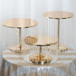 Metallic gold cake stand with crystal chains, 12" tall and 14" round.