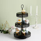 Black 3-tier cupcake stand with assorted desserts and decorative elements.