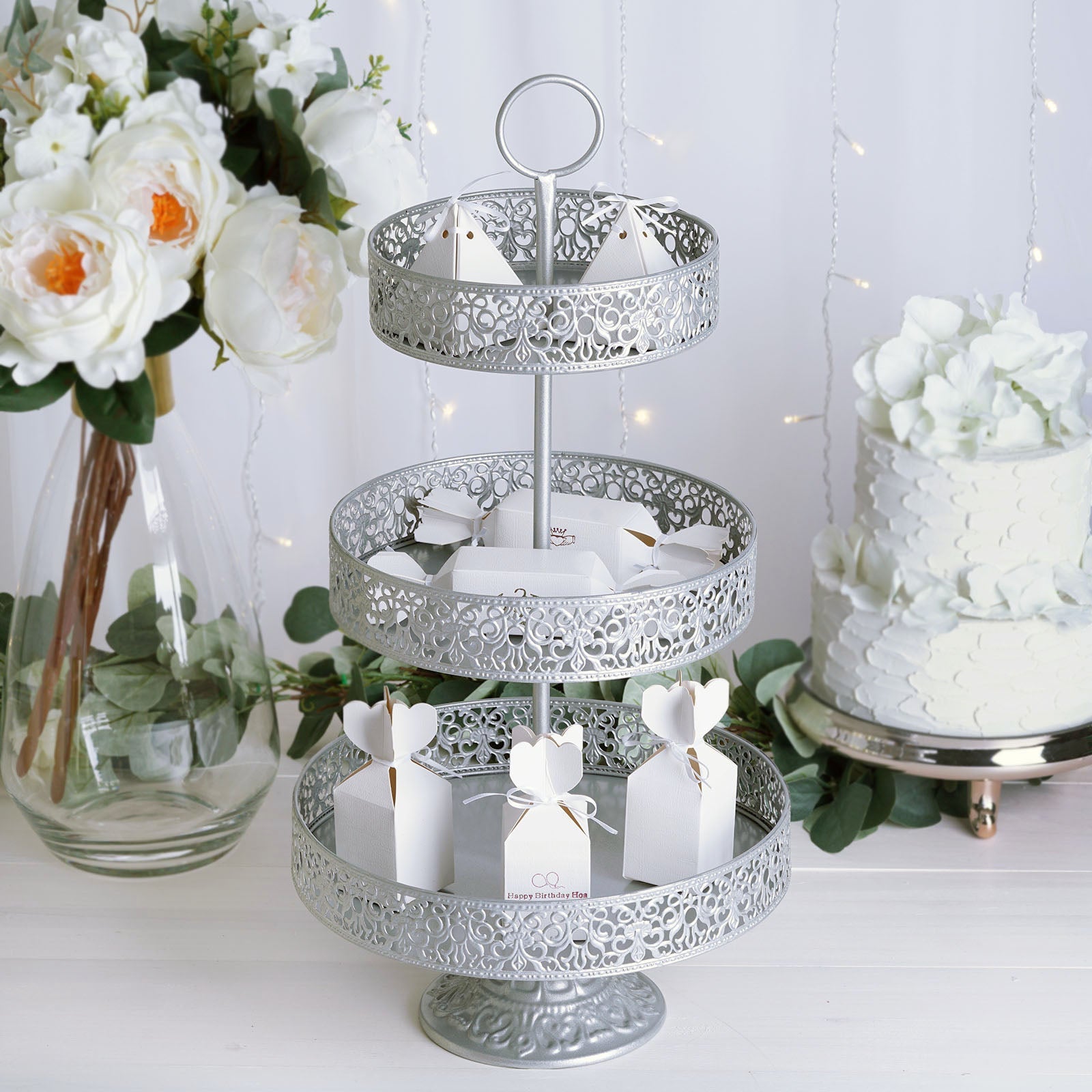 Silver 3-tier cupcake stand with elegant design and decorative display.
