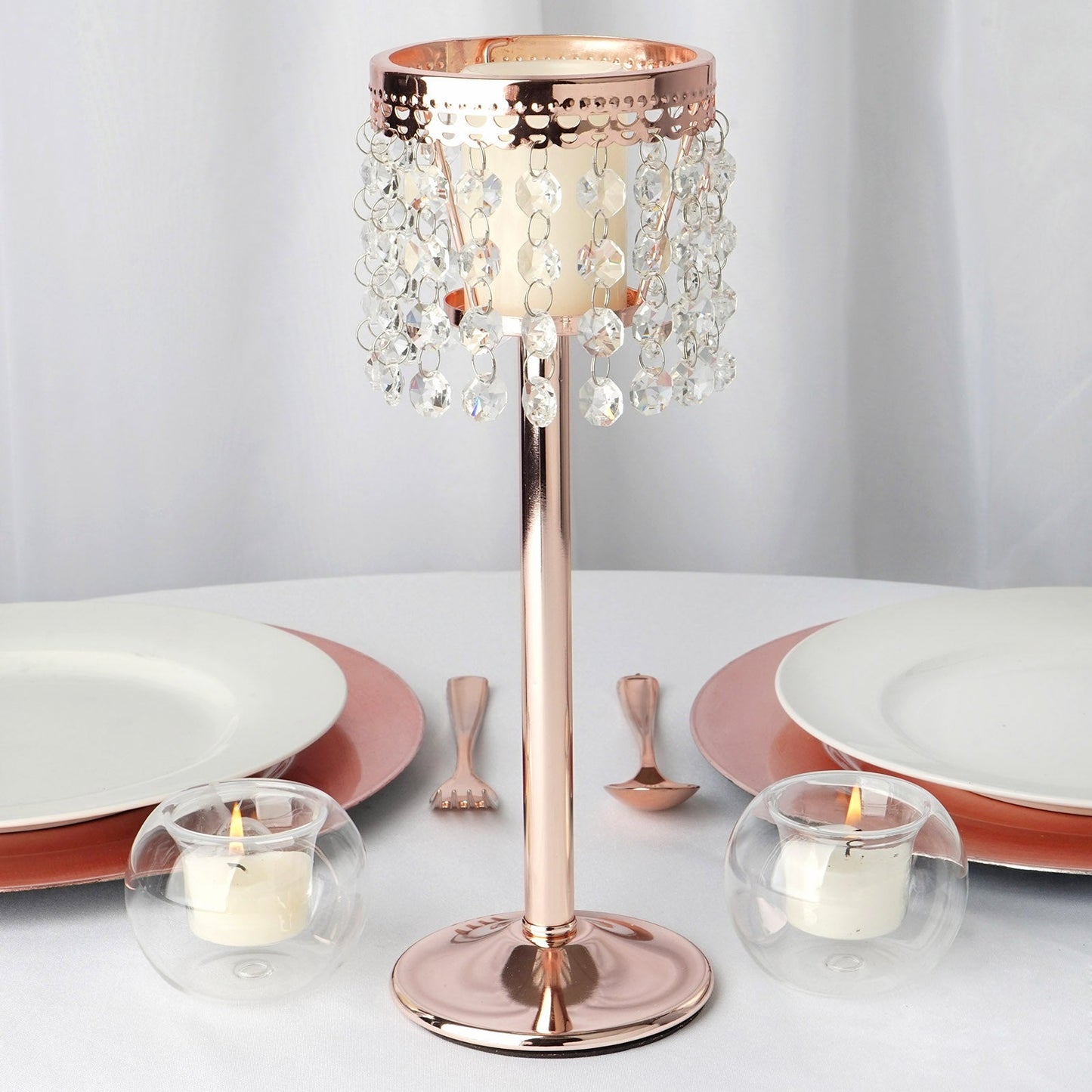 Rose gold crystal beaded chandelier candle holder on a table setting.
