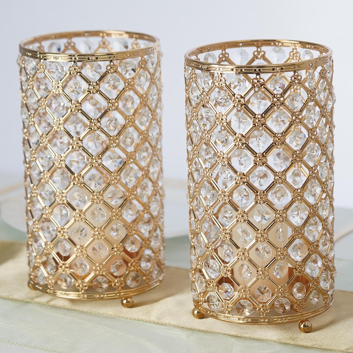 Gold crystal beaded candle holders set for elegant decor.