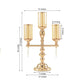 Gold metal 3 arm candelabra with amber glass shades for pillar candles.