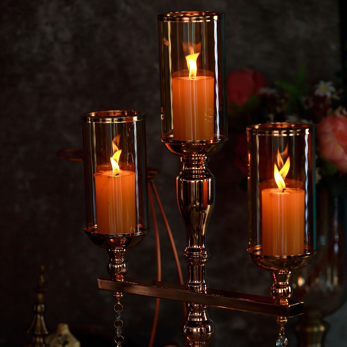 Gold 3 arm candelabra with amber glass shade and hurricane candle holders.