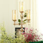 Gold 3 arm candelabra with amber glass shades and floral decor.
