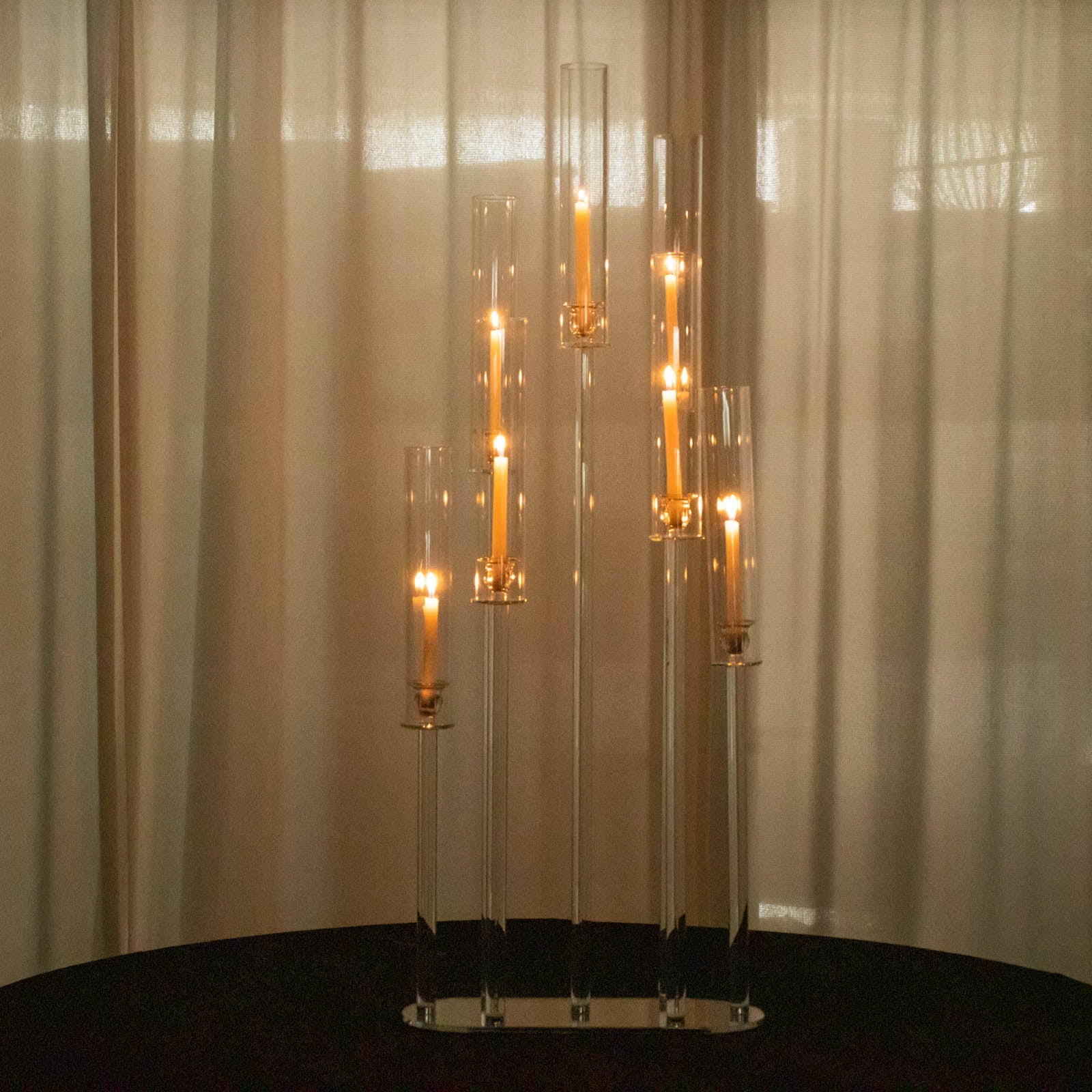 Clear crystal 7-arm candelabra centerpiece with hurricane shades and taper candles.