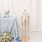 Gold taper candle holder with clear glass shades in a stylish arrangement.