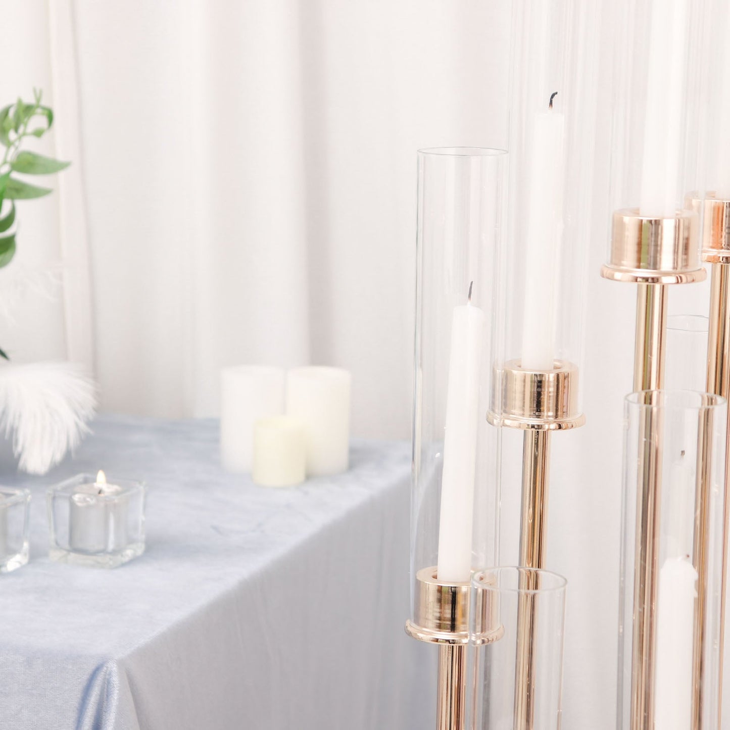 Gold 10 arm taper candle holder with clear glass shades.