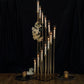 Gold 12 arm candle holder with clear glass shades and taper candles.