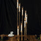 Gold 8 arm taper candle holder with clear glass shades, large candle arrangement.