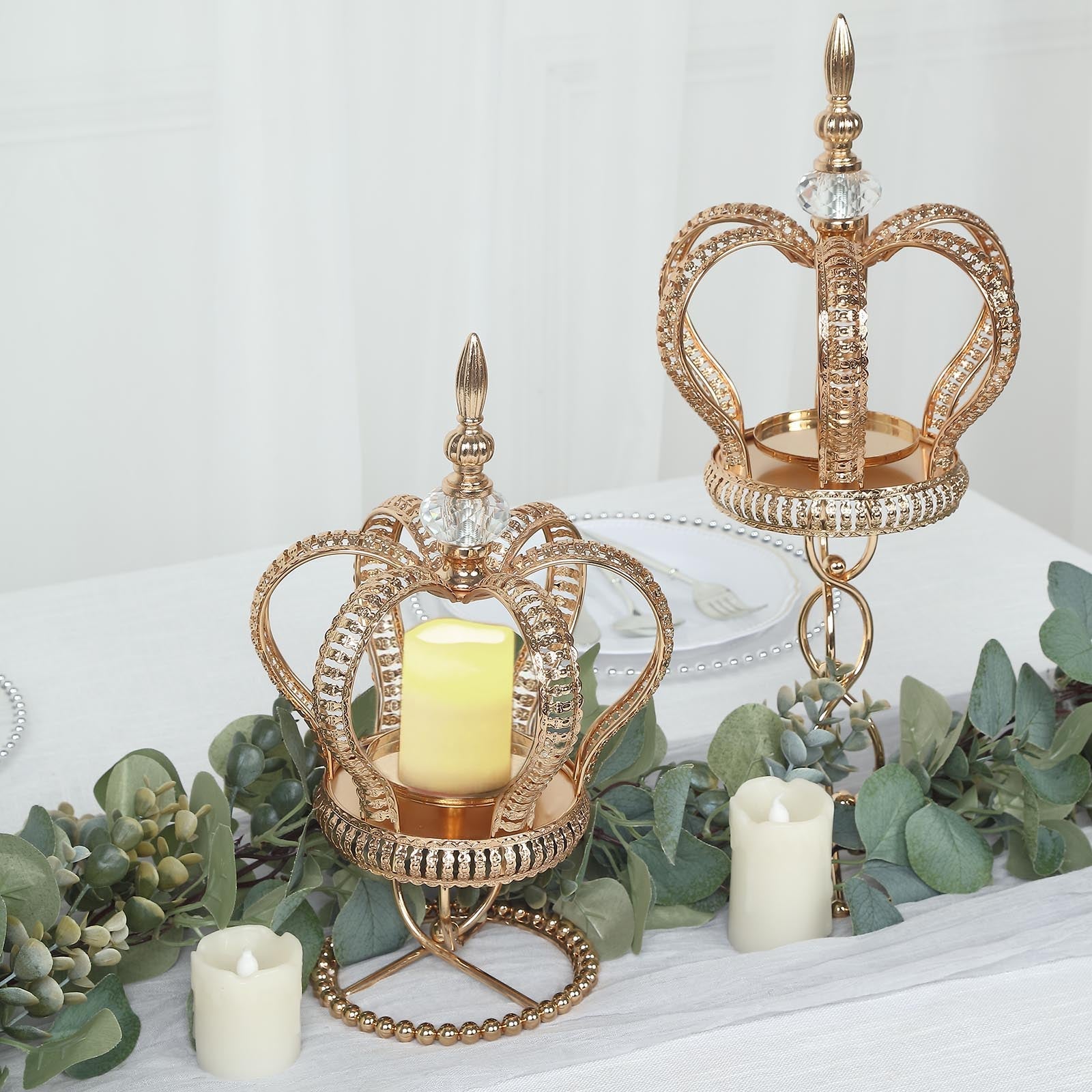 Gold metal crown candle holder stand with jeweled accents.