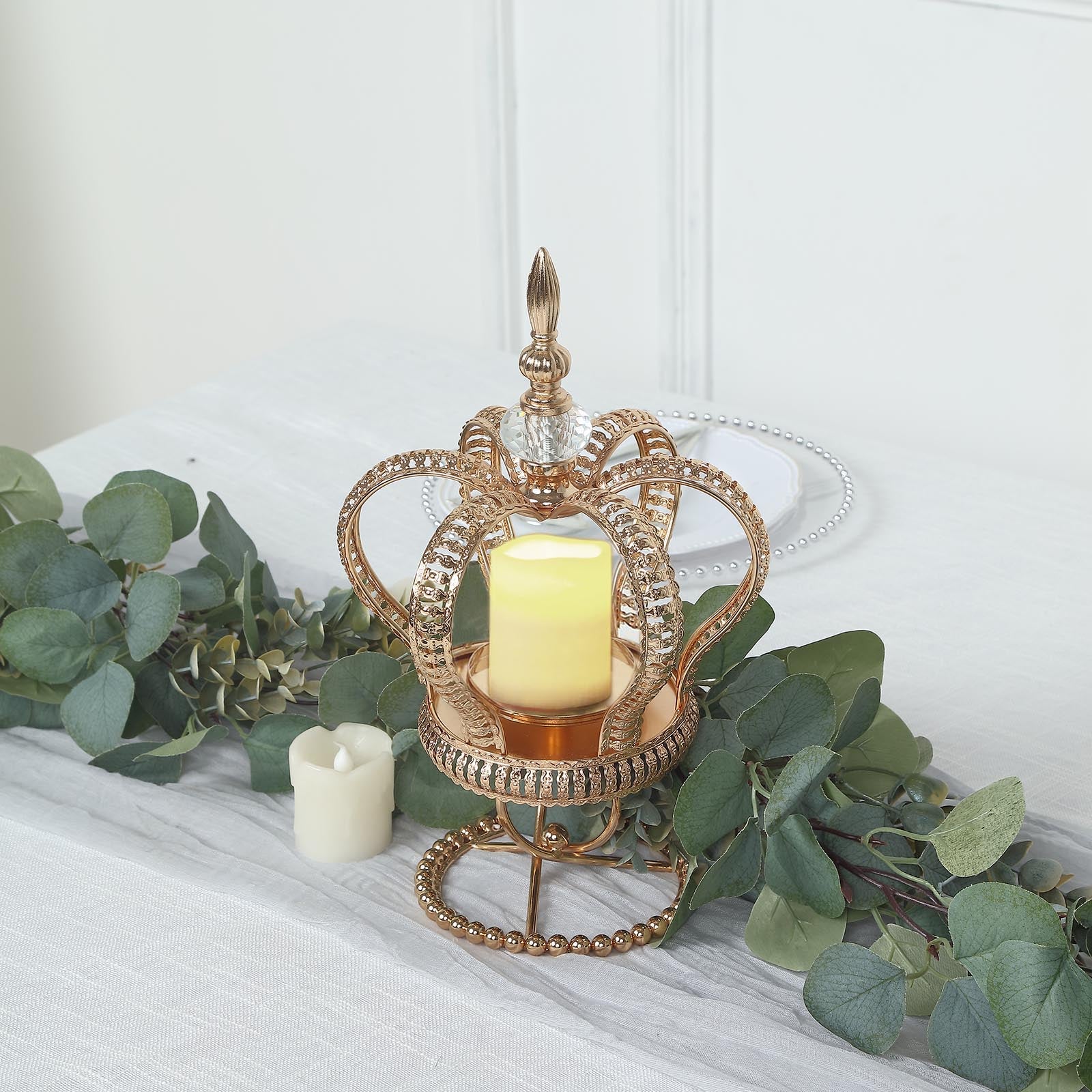 Gold crown candle holder with jeweled accents and votive candle centerpiece.