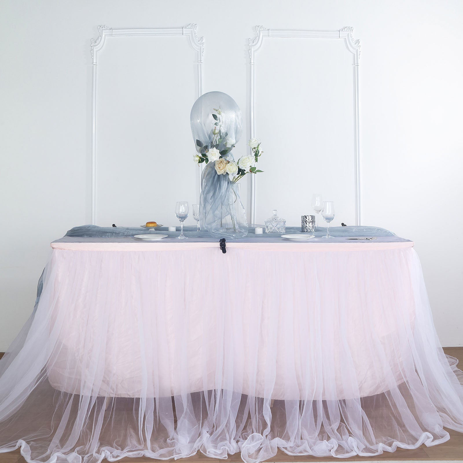 Dusty blue sheer chiffon fabric draped elegantly on a table.
