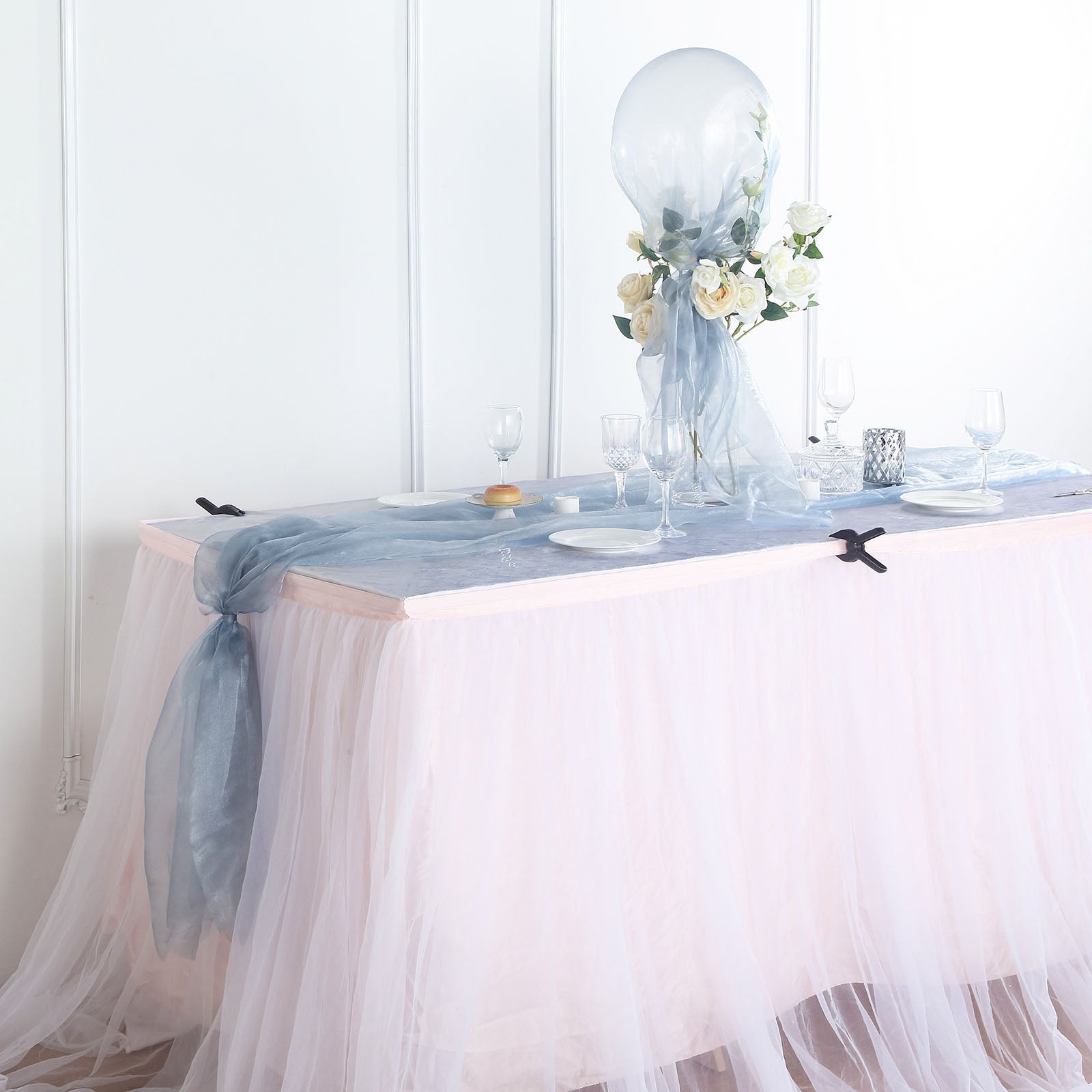 Dusty blue sheer chiffon fabric draped elegantly on a table.