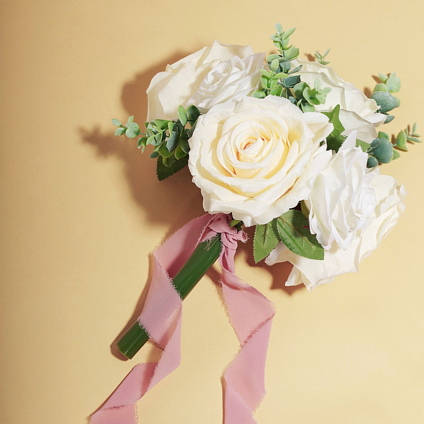Dusty rose chiffon ribbon with bouquet of white roses and greenery.