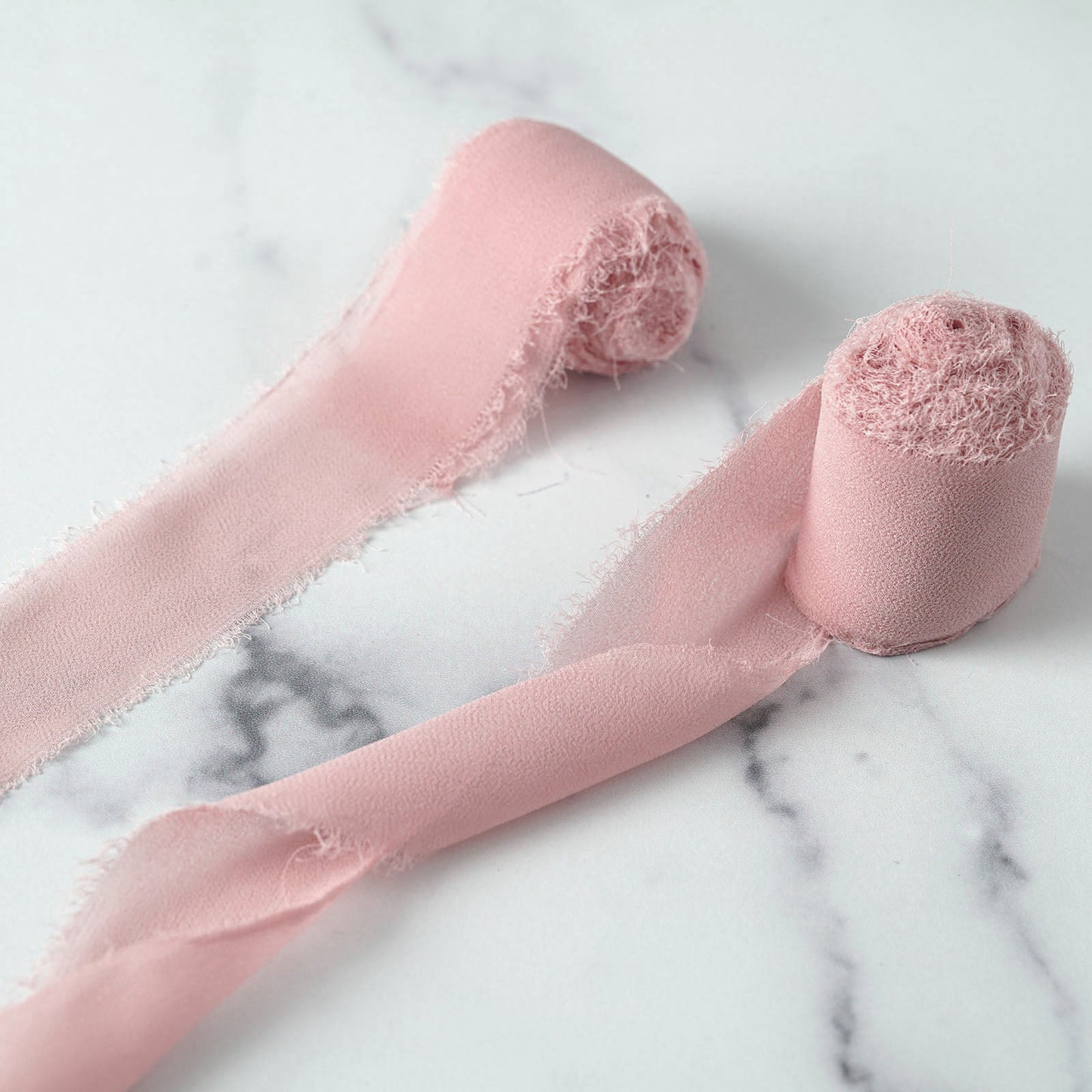 Dusty rose silk-like chiffon ribbon rolls for bouquets and gift wrapping.