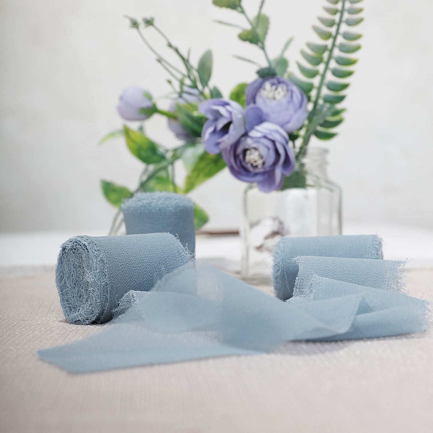Dusty blue chiffon ribbon rolls for wedding bouquets and gift wrapping.